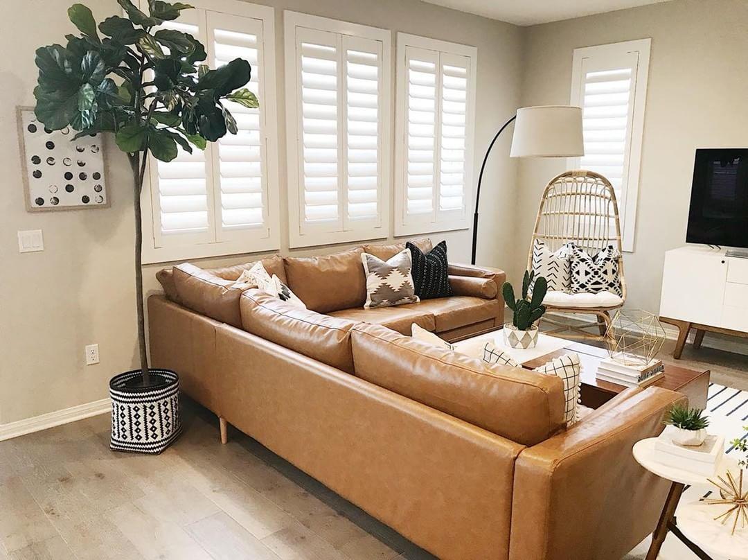 Warm living room with our Polywood shutters in Raleigh.